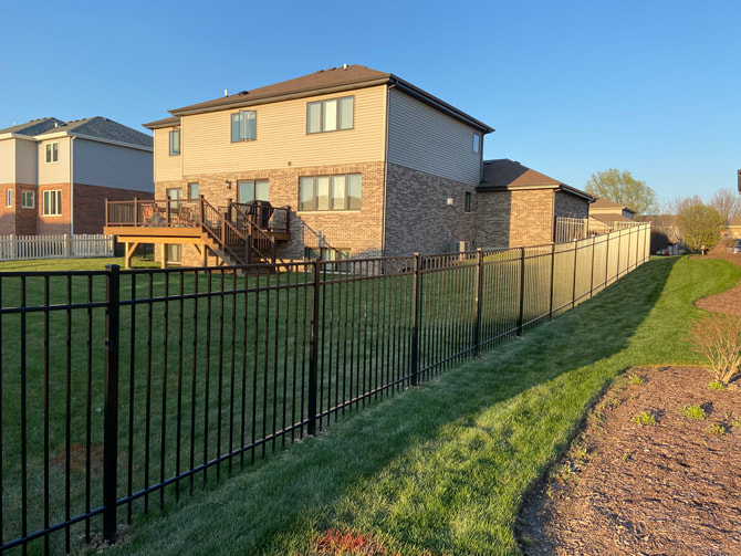 Black aluminum residential fence installed in Homer Glen, Illinois