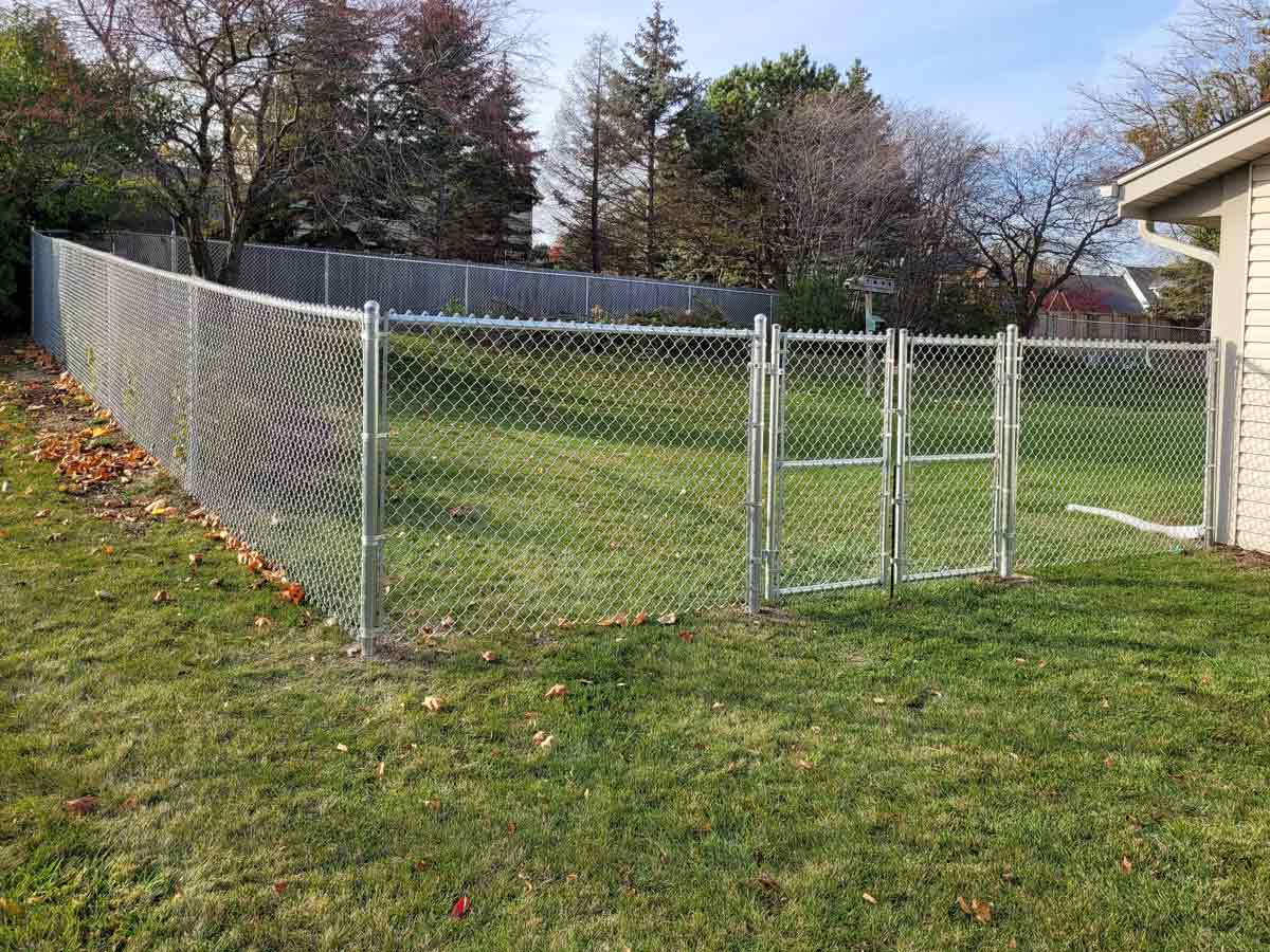 Galvanized chain link fence with a gate installed in Round Lake, Illinois